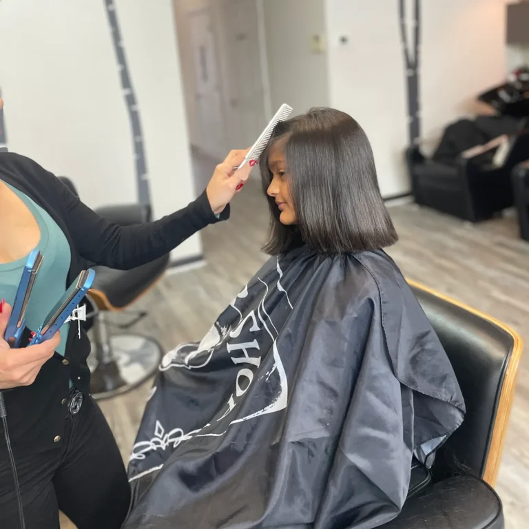 Stylist combing through a freshly cut blunt bob