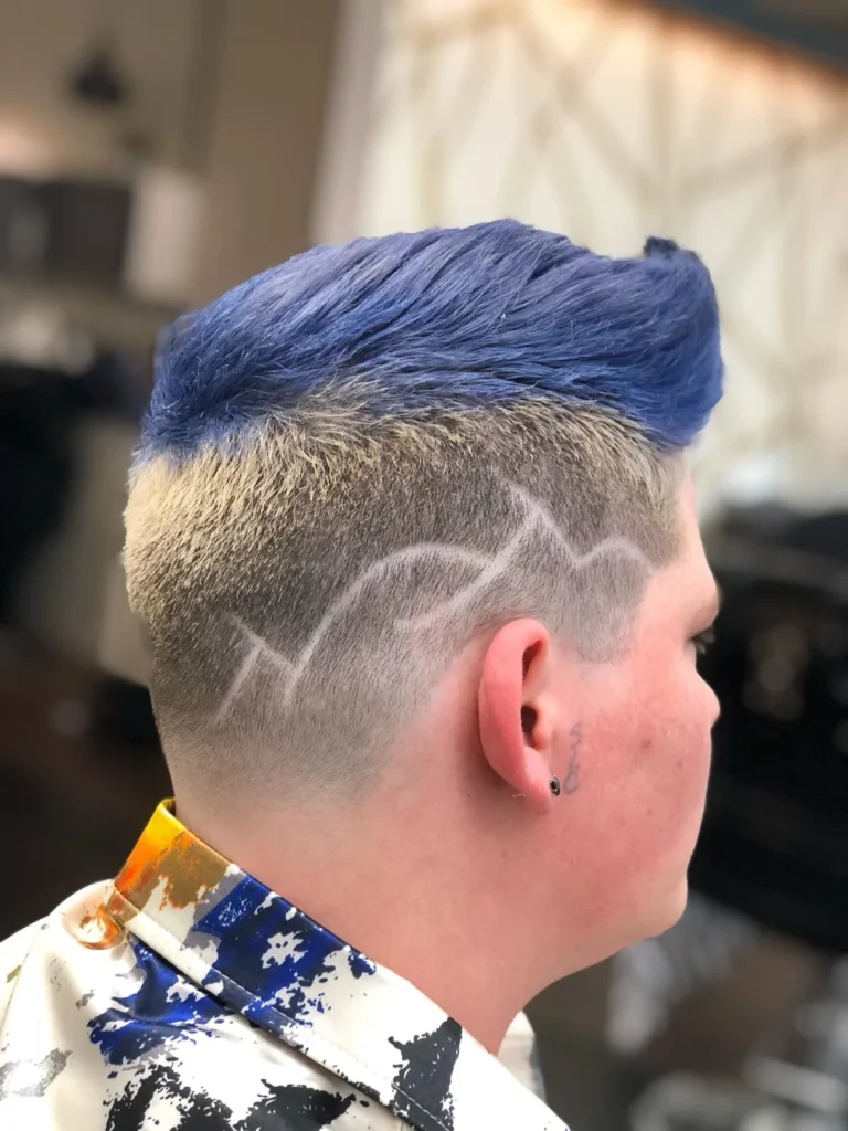 Boy with blue-coloured hair and a lightning bolt shaved into the fade