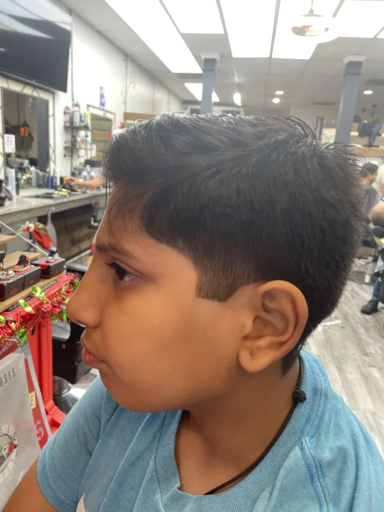 Boy in profile after a short crop cut with clippers and scissors