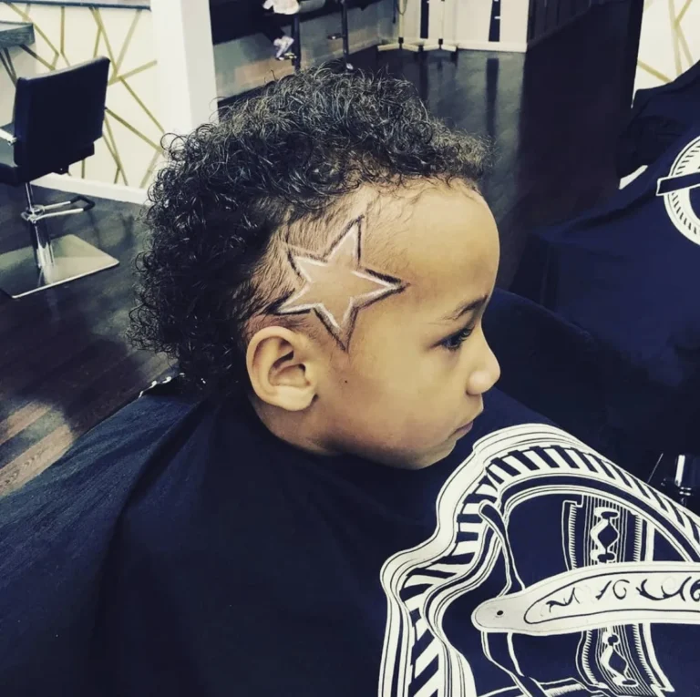 Small boy with a star shaved into the side of his curly hair