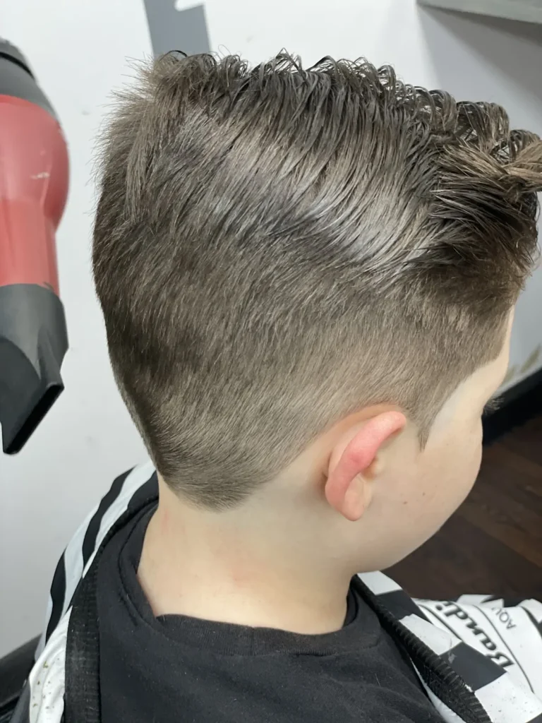 Boy’s textured quiff being blow-dried, taper down the sides
