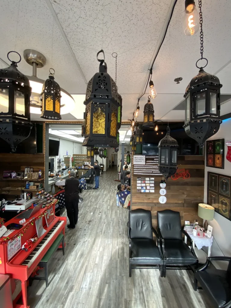 Moroccan lanterns hanging over the aisle between the barber chairs