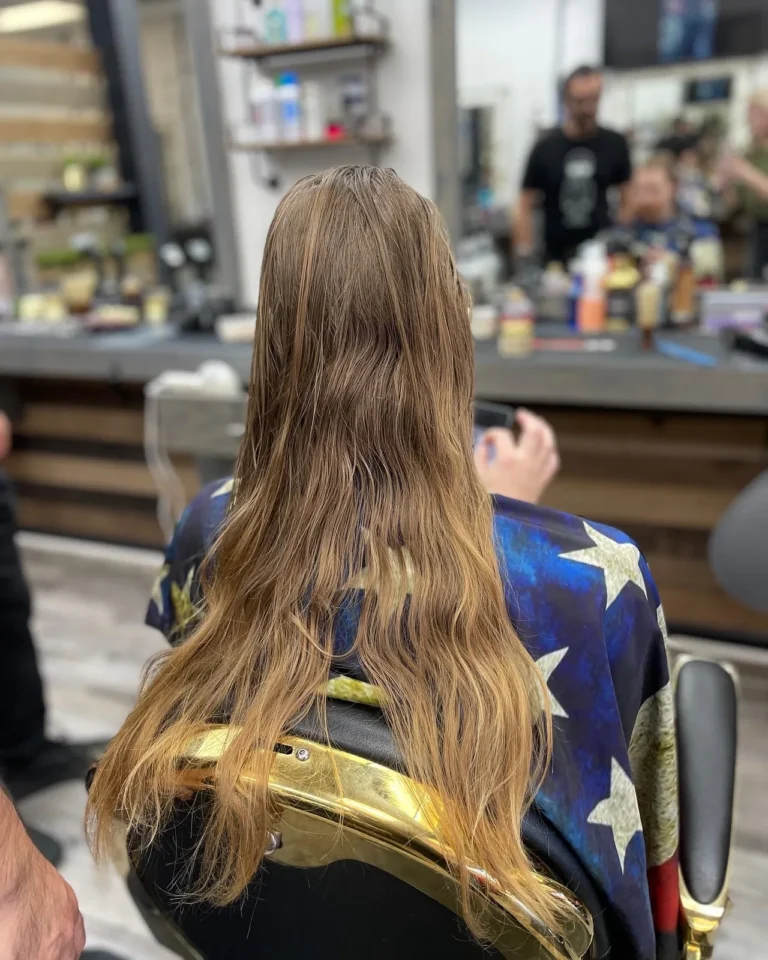 Long layered hair with warm colour, seen from behind in the chair