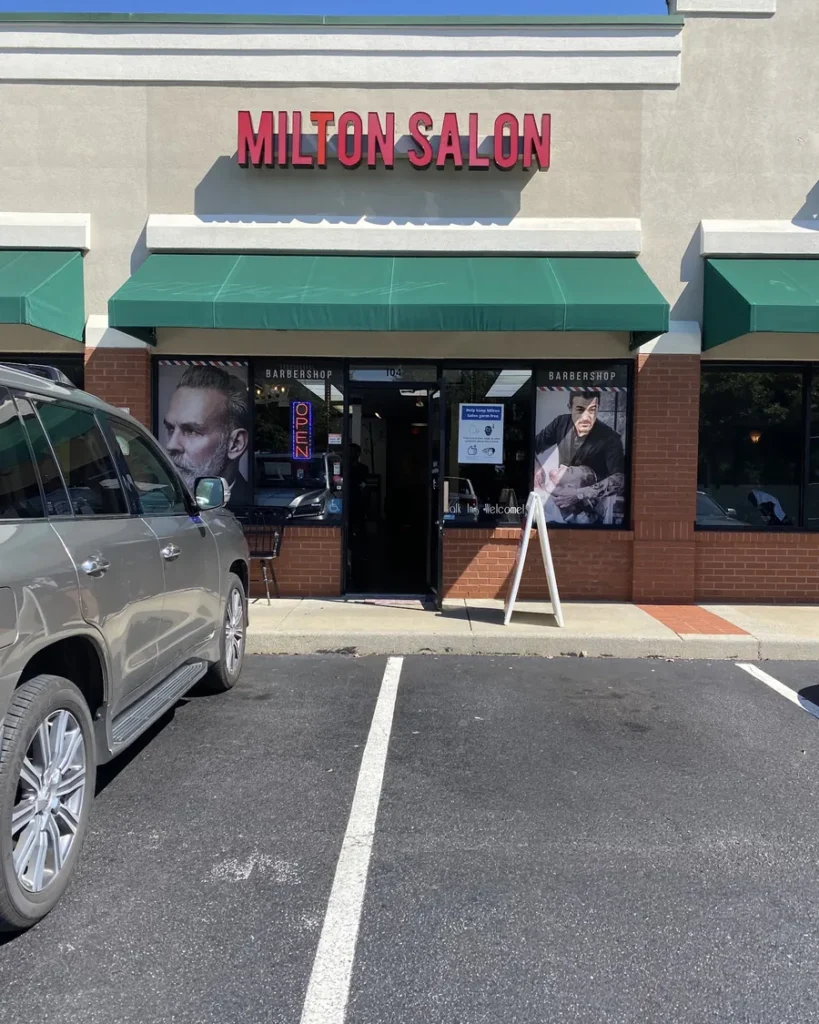 The Milton Salon storefront: red letters over a green awning, Suite 104 in the Old Milton Festival plaza, Alpharetta
