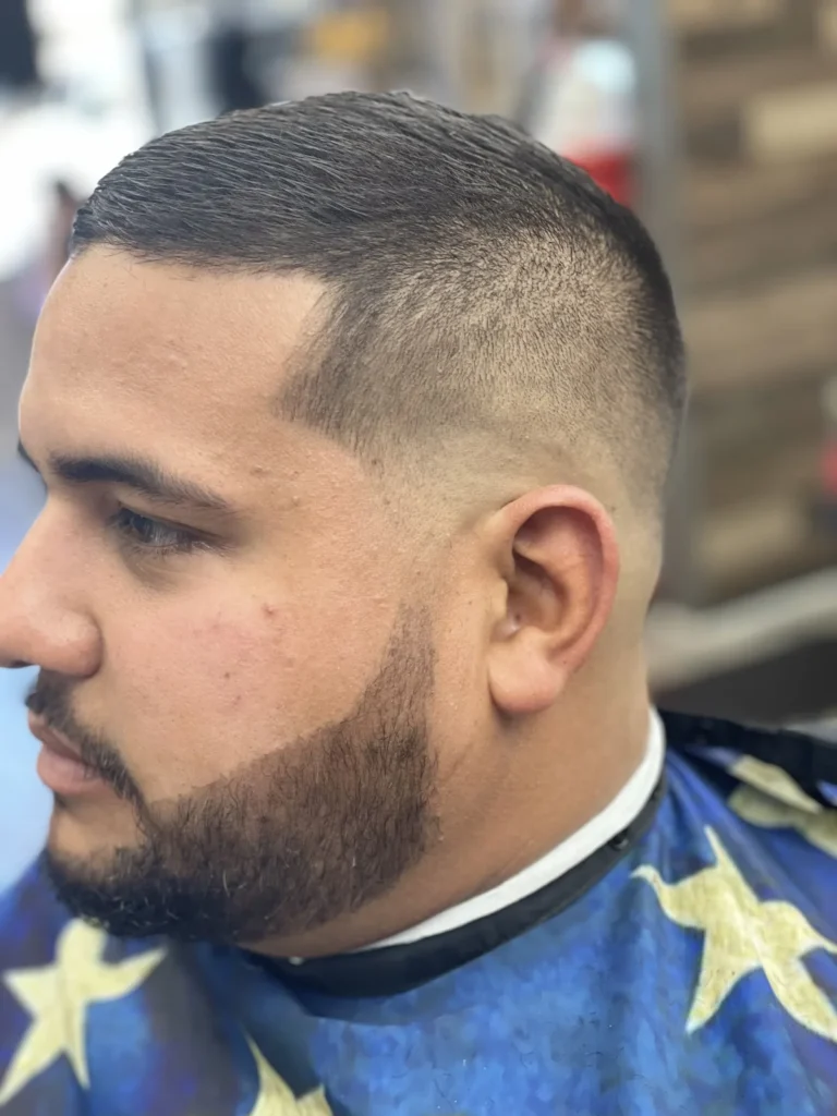Man with a short crop and a neatly trimmed beard, side view