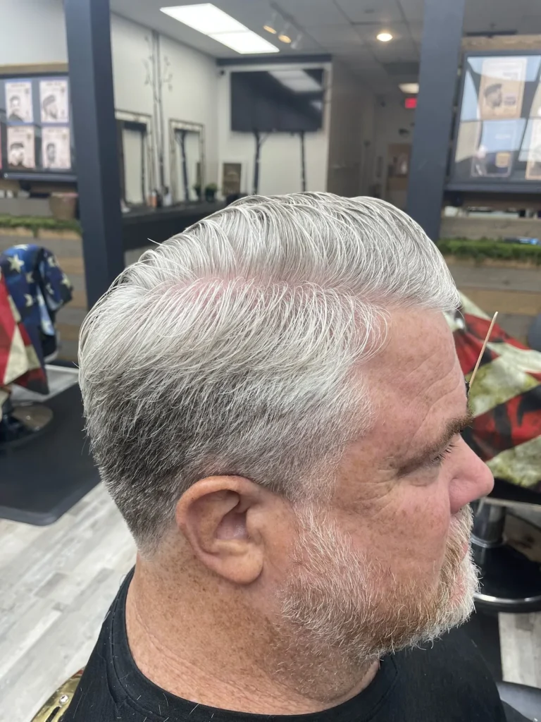Older man with silver hair, freshly scissor cut, and a trimmed beard
