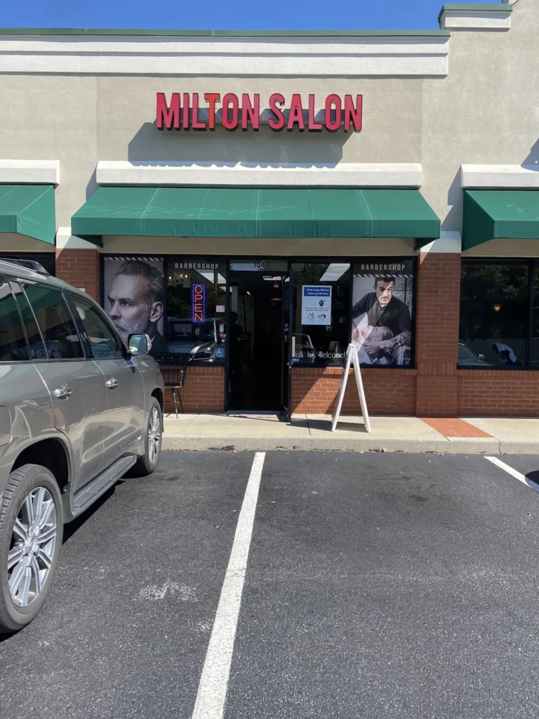 The Milton Salon storefront and its parking spaces on Old Milton Parkway